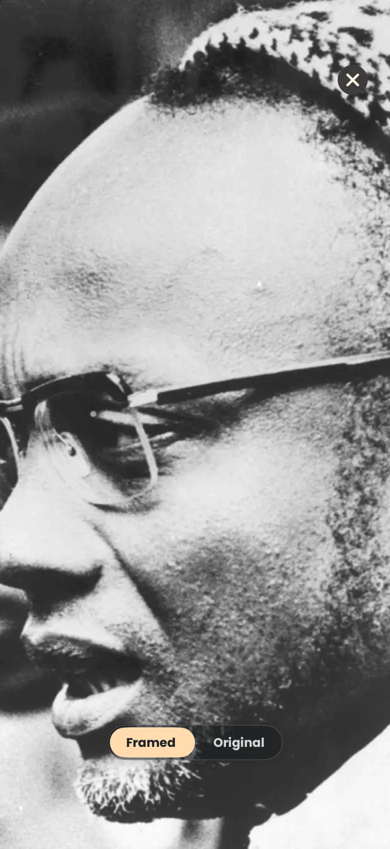 A full-screen black and white photograph of a man in glasses, with a Framed and Original switch at the bottom and a close button at the top right.